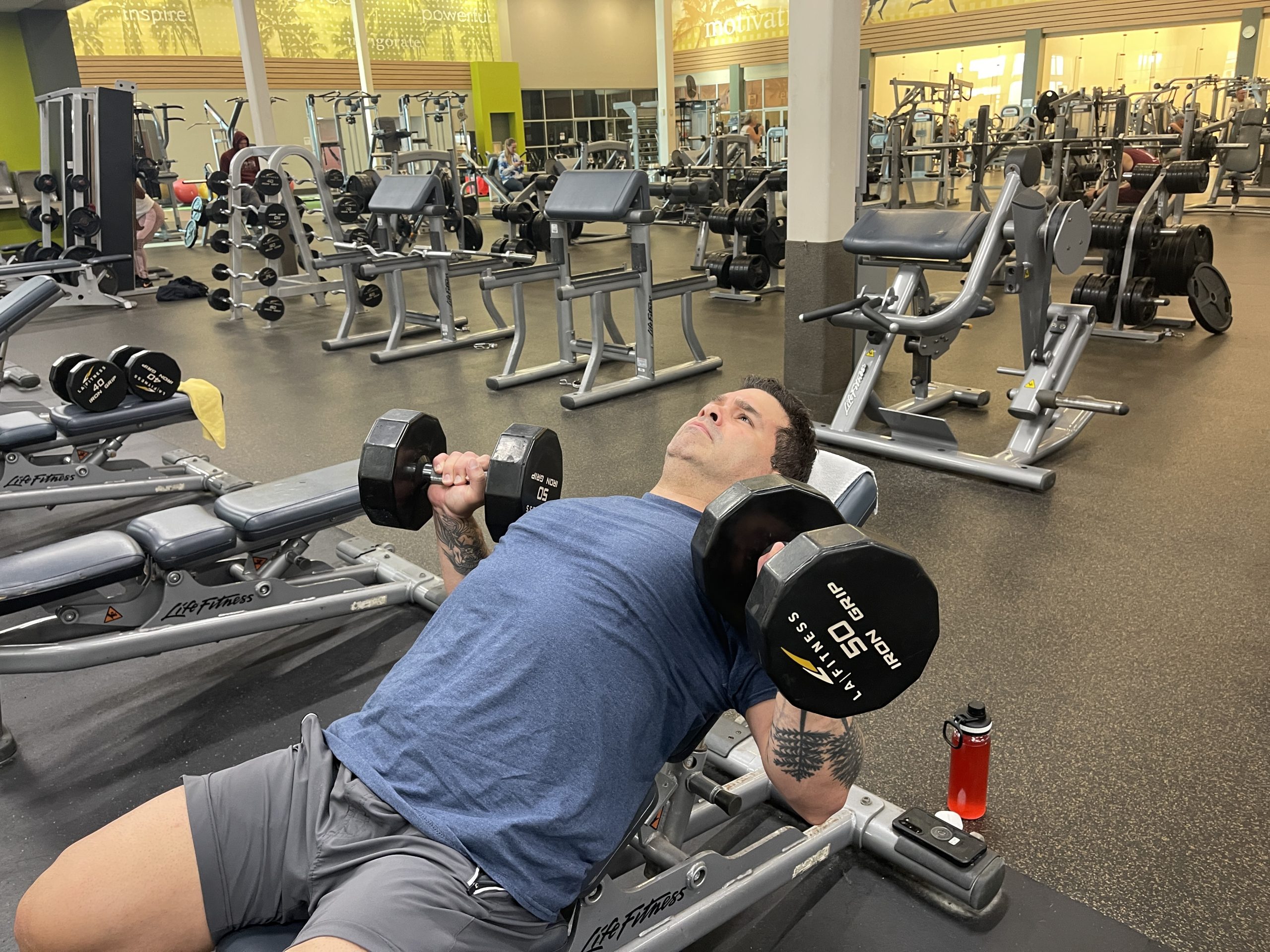 Online personal training client working out at a commercial gym