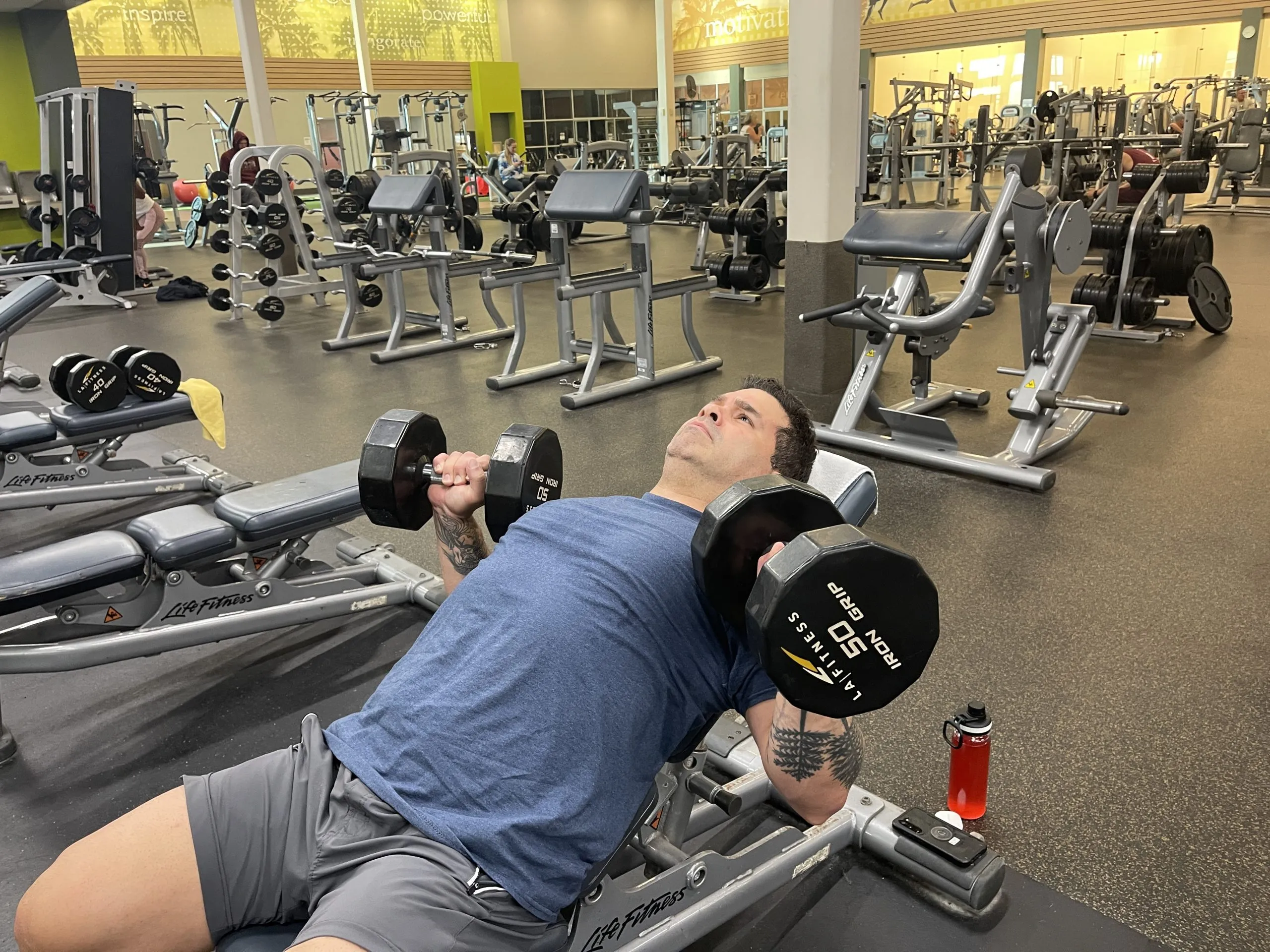 Online personal training client working out at a commercial gym