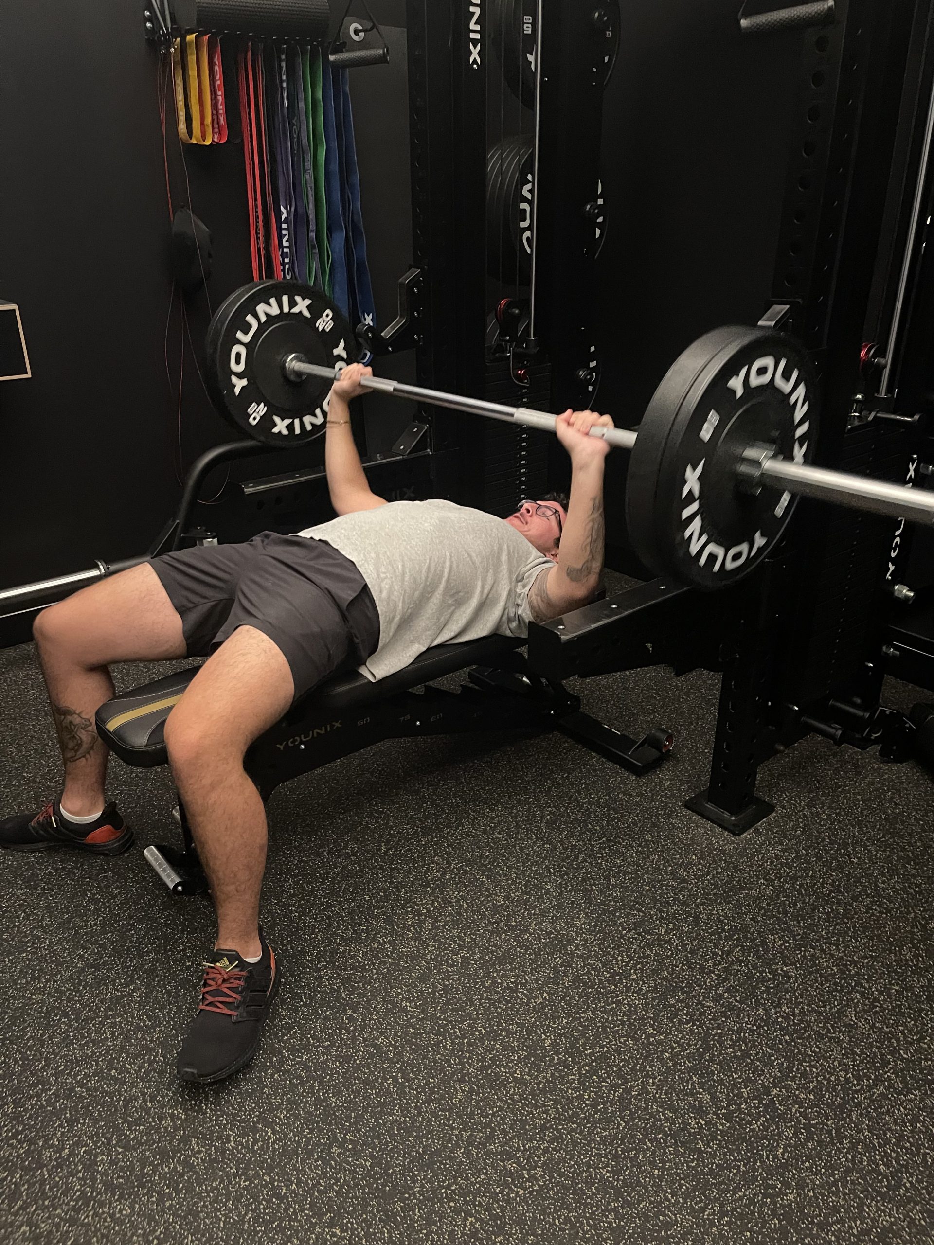 Client bench pressing at FlexWerk Fitness in Carmel, Indiana