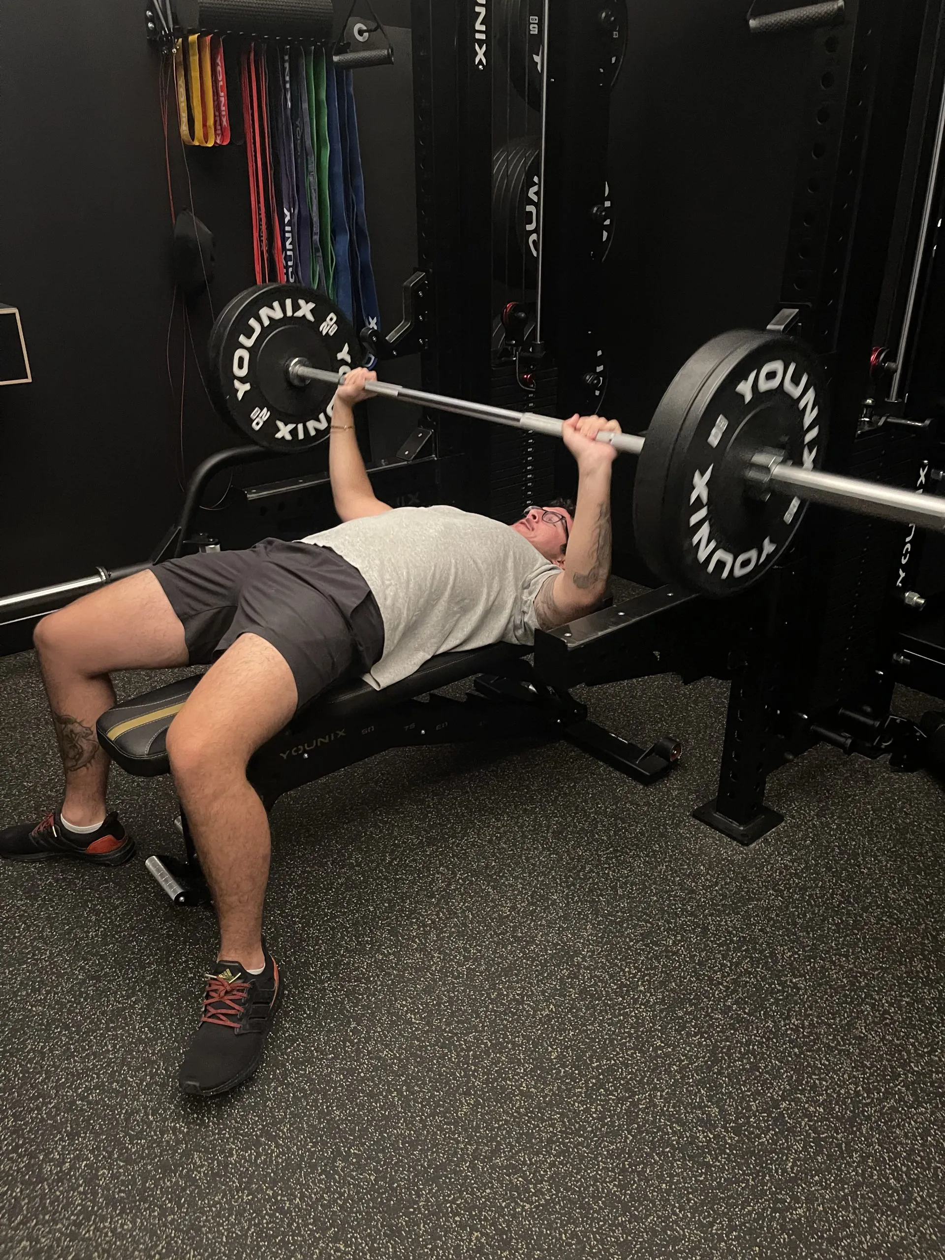 Client bench pressing at FlexWerk Fitness