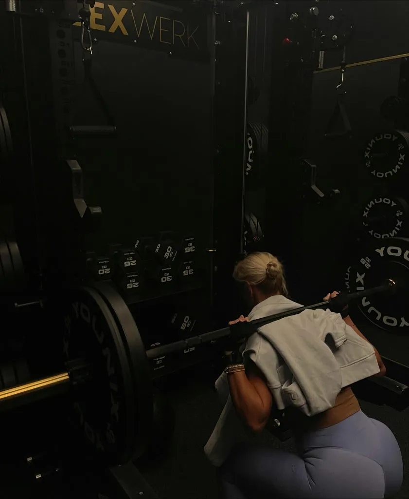Personal training client back squatting at FlexWerk Fitness in Carmel, Indiana