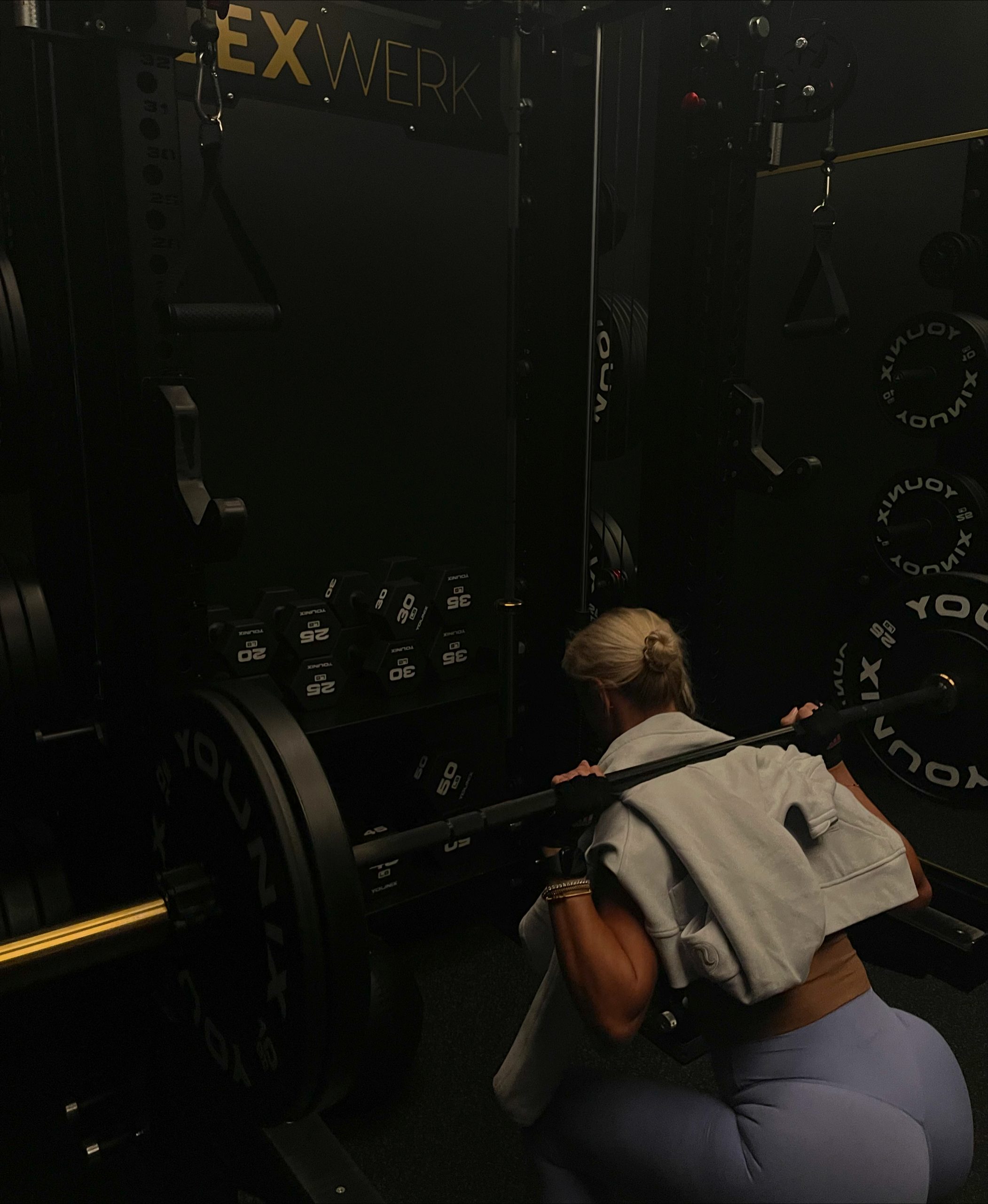 Personal training client back squatting at FlexWerk Fitness in Carmel, Indiana